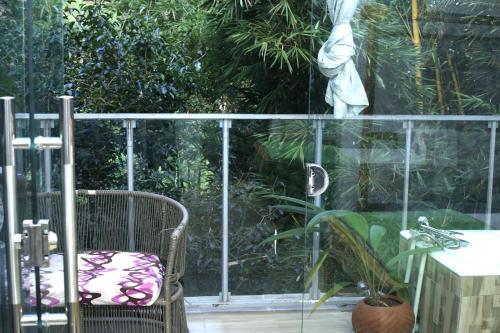 a statue in a garden with a chair and a table at Nkofu Forest Cottage - Kitende in Wakiso