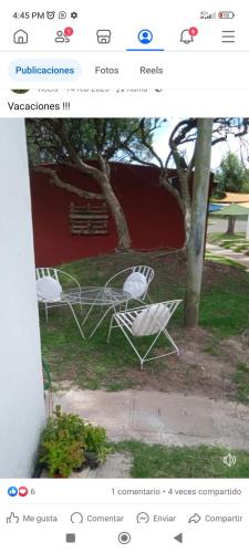 a page of a website with two white chairs at Alojamiento in Fray Bentos