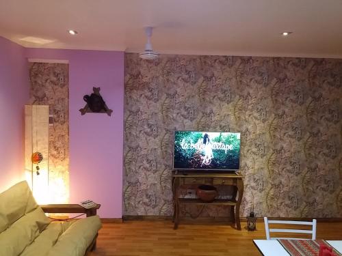 a living room with a couch and a flat screen tv at Casa 24 Puerto Iguazu in Puerto Iguazú