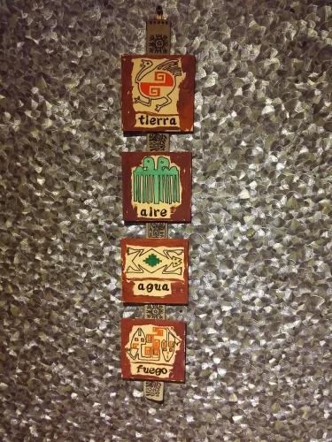 a group of signs on the side of a wall at Casa 24 Puerto Iguazu in Puerto Iguazú