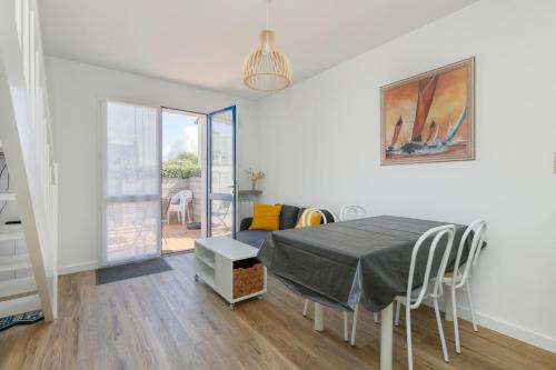 une salle à manger avec une table et des chaises dans une pièce dans l'établissement Petite maison -, au Croisic