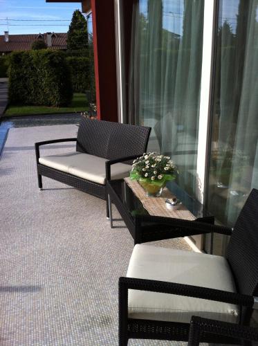 a patio with two chairs and a table with at Relais Villa Annamaria Bed end Breakfast in Istrana