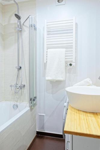 une salle de bain blanche avec un lavabo et une douche dans l'établissement Le La Fayette Confort & calme avec parking privé, à Versailles