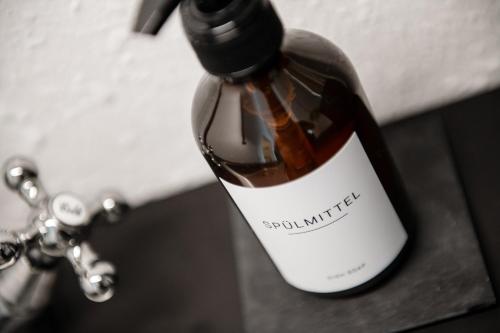 a bottle of wine sitting on top of a sink at Relax Apart Bonn in Bonn