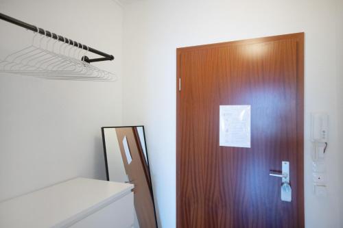 a wooden door in a room with a white wall at Relax Apart Bonn in Bonn