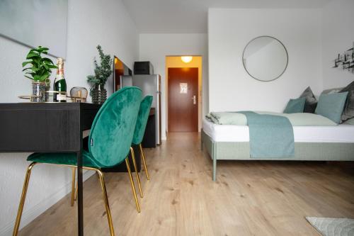 a bedroom with a bed and a desk and chairs at Relax Apart Bonn in Bonn