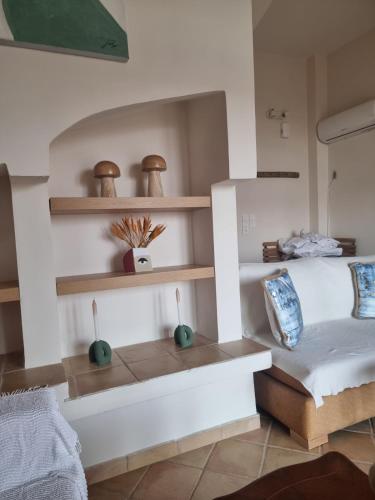 a bedroom with white walls and wooden shelves at Villa Rodi in Galaxidi