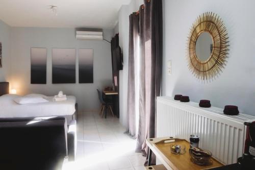 a bedroom with a bed and a mirror and a table at Gk Suites-Constantin view , auto check-in 24h in Larisa