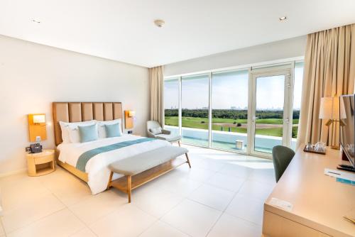 a bedroom with a bed and a large window at Zoya Health & Wellbeing Resort in Ajman 