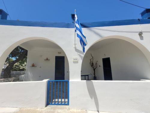 a white building with a blue gate and a flag at 1939 in Kinion