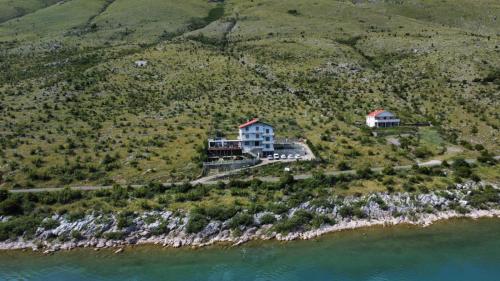 an aerial view of a house on an island in the water at Bella Vista in Shkodër