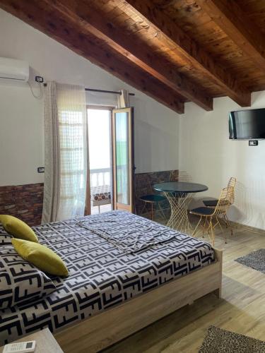 a bedroom with a bed and a table with chairs at Bella Vista in Shkodër