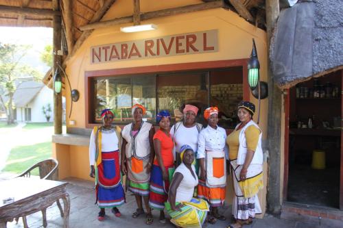 a group of people standing in front of a restaurant at N'taba River Lodge & Spa in Port St Johns