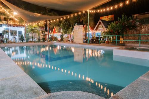 a swimming pool at night with christmas lights at Villa Leonida Resort in Bugallon