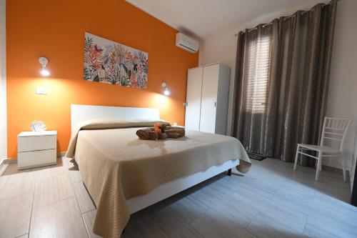 a bedroom with a bed with a teddy bear on it at AL Quadrifoglio in Terrasini