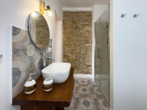 a bathroom with a sink and a mirror at La casa di nonna Pietra in Baunei