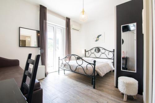a bedroom with a bed and a chair and a window at Villa Liliana in Cervia