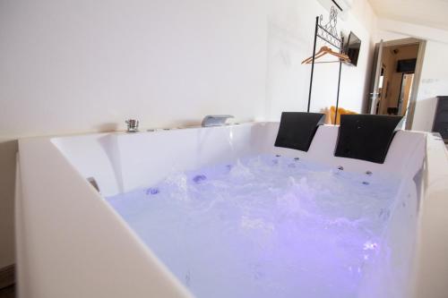 a white bath tub with two chairs in it at Villa Liliana in Cervia