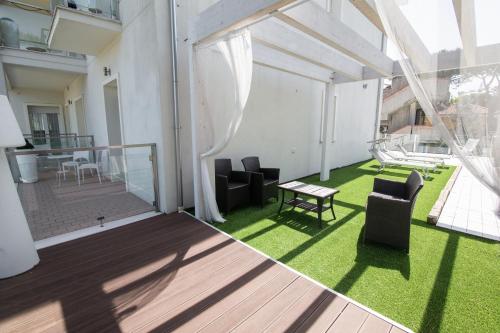 a balcony with chairs and a table in a building at Villa Liliana in Cervia