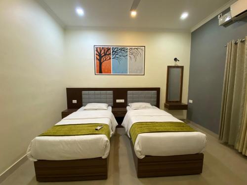 Katil atau katil-katil dalam bilik di Muziris Manor Residency