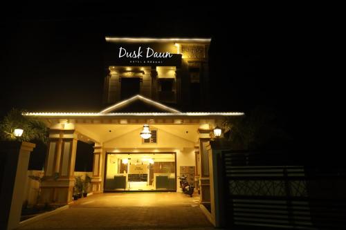 a building with a sign that reads back drain at night at Hotel Dusk and Dawn in Rāmeswaram