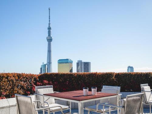 a table and chairs with a view of the city at The Gate Hotel Kaminarimon by Hulic in Tokyo
