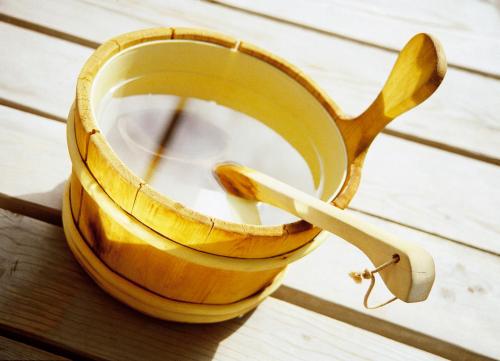 a wooden cup of coffee on a wooden table at Hotel Garni Aurora in Samnaun