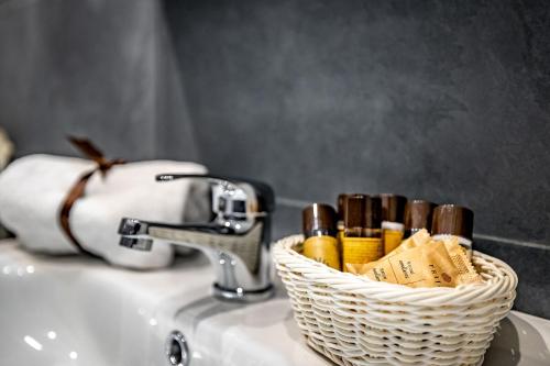 a basket of matches sitting on a bathroom sink at La Corte di Ripoli in Bagno a Ripoli