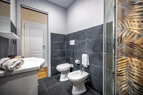 a bathroom with a toilet and a sink and a shower at La Corte di Ripoli in Bagno a Ripoli