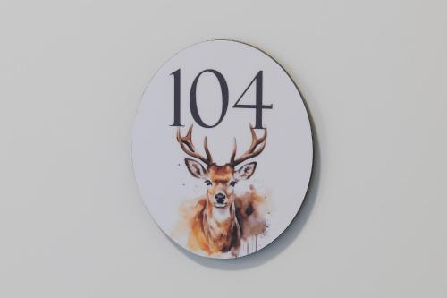 a clock with a picture of a deer at Hotel Jäger Jeuss - Murten - Self-Check-in in Jeuss