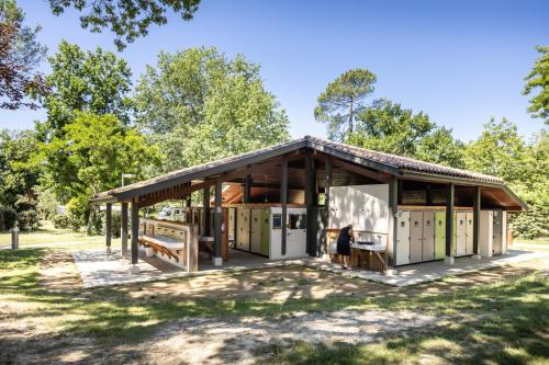a rendering of a small house in a park at Huttopia Lac de l'Uby - Gers in Cazaubon