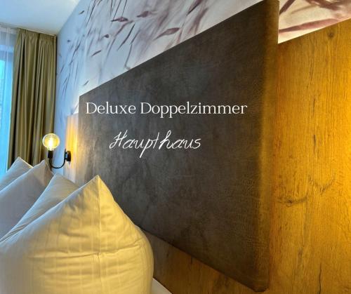 a hotel room with a sign on the wall at Hotel Schwaiger in Glonn