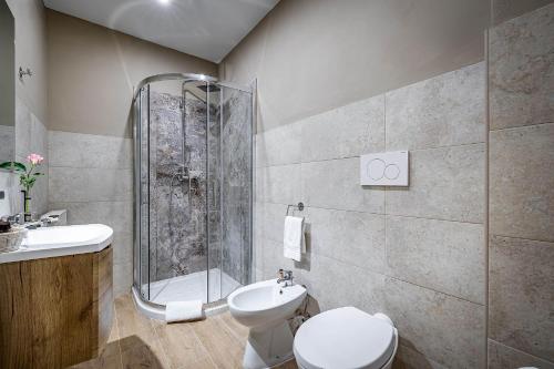 a bathroom with a shower and a toilet and a sink at La Corte di Ripoli in Bagno a Ripoli