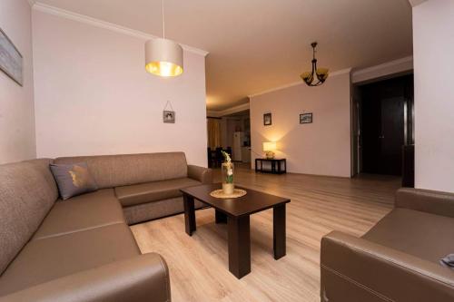 a living room with a couch and a table at cosy apartment in Kokotauri