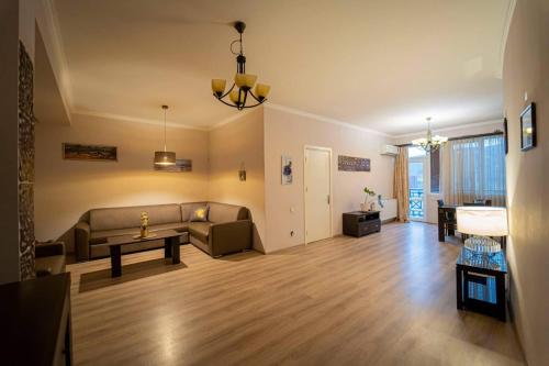 a living room with a couch and a table at cosy apartment in Kokotauri