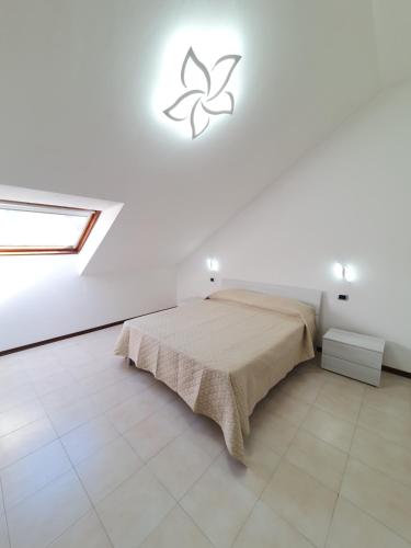 a bedroom with a bed in a white room at casa vacanze Veronica in Soviore