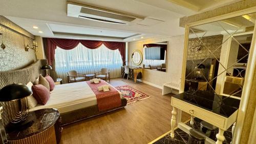a hotel room with a large bed and a large mirror at Burj Al Istanbul in Istanbul