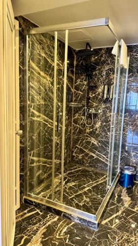 a glass shower in a bathroom with a marble floor at Burj Al Istanbul in Istanbul