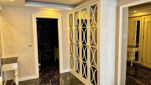 a hallway with a door with a gold patterned wall at Burj Al Istanbul in Istanbul