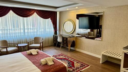 a hotel room with a bed and a mirror at Burj Al Istanbul in Istanbul