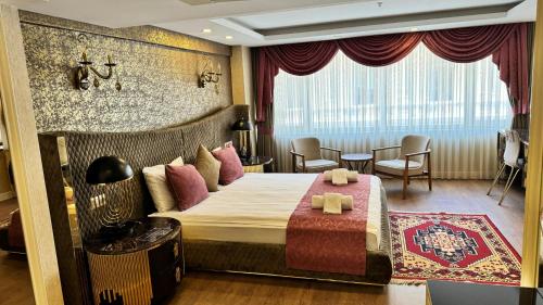 a hotel room with a bed and a table and chairs at Burj Al Istanbul in Istanbul