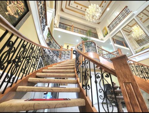 a spiral staircase in a house with a chandelier at The Empress Palace Hotel in Surrey