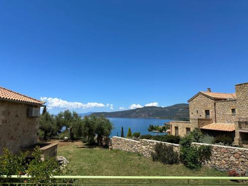a view of a lake from a stone wall at Amoni Holiday Homes in Kardamili