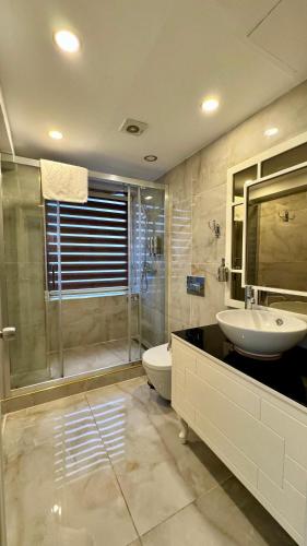 a bathroom with a sink and a toilet and a shower at Burj Al Istanbul in Istanbul