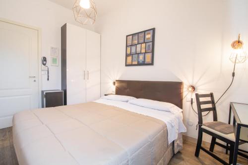 a bedroom with a bed and a desk and a chair at Villa Liliana in Cervia