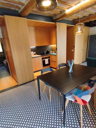 a kitchen with a table and chairs in a room at The View - Sunset & Relax - Suite - Appartamenti Vista Lago in Passignano sul Trasimeno