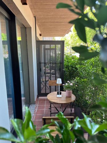 a patio with a table and some plants at Boutique Hotel Sirmione in Sirmione