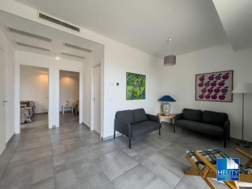a living room with two couches and a table at CALALUNGA PIETRAGRANDE - Exclusive Shoreline Haven in Montepaone Lido
