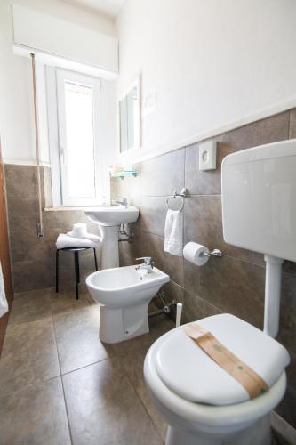 a bathroom with a toilet and a sink at Villa Liliana in Cervia