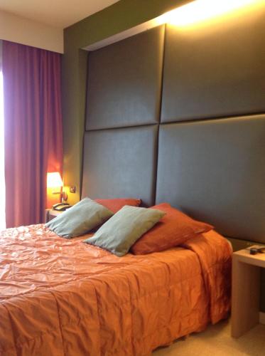 a bedroom with a large bed with an orange blanket at Relais Villa Annamaria Bed end Breakfast in Istrana